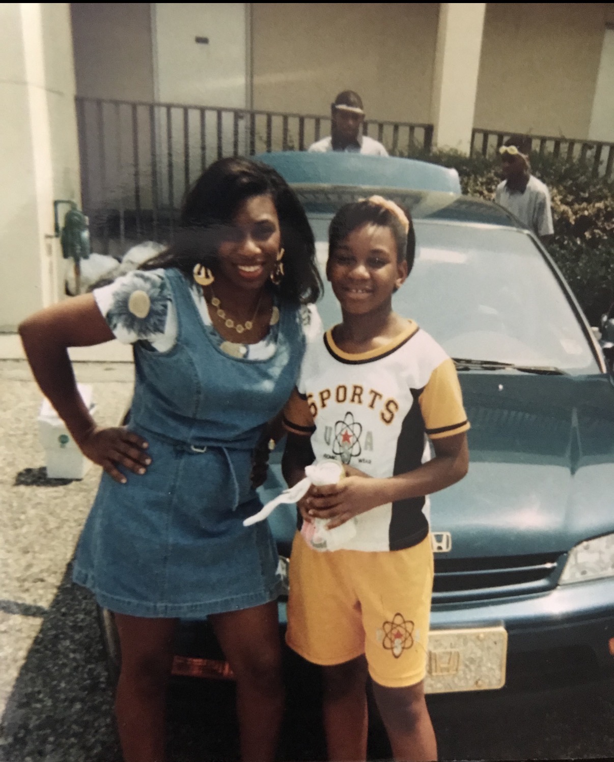 The founder of Connecting the Gap as a child, standing with her mom.
